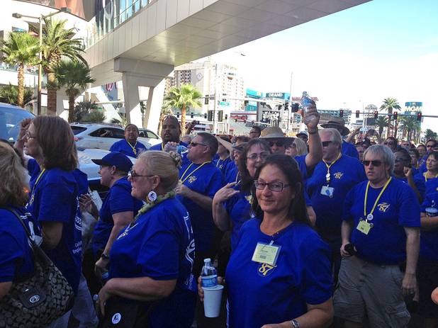 Members of the California School Employees Association — clad in blue — protest outside the Cosmopolitan, Wednesday, July 31, 2013.