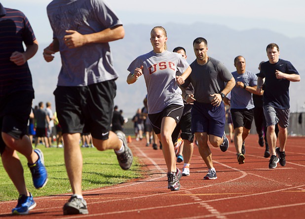 Metro Police recruit candidate run laps for one mile during  physical fitness testing at Cimarron-Memorial High School Thursday, Aug. 1, 2013. The mile run must be completed in 10 minutes and 49 seconds or less.