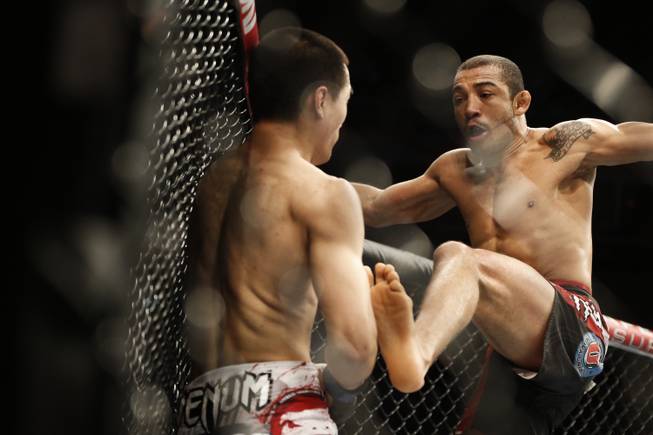 Jose Aldo, from Brazil, right, and Chan Sung Jung, from South Korea, battle during their UFC 163 mixed martial arts Featherweight Championship bout in Rio de Janeiro, Brazil, Sunday, Aug. 4, 2013. Aldo defeated Jung and kept his Championship belt.