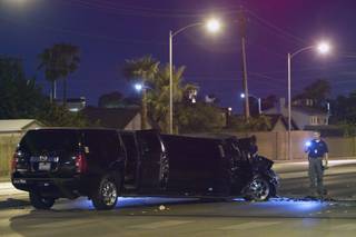 Metro Police Sgt. Richard Strader investigates an accident involving five vehicles, including a limousine, at Rainbow Boulevard and Twain Avenue on Saturday, Aug. 3, 2013. Several people were reported injured in the accident.