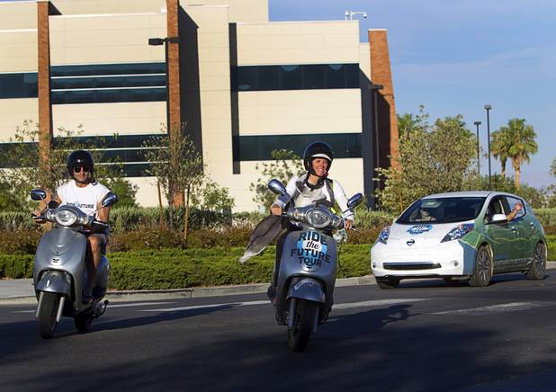 Jason Taylor, left, and Susan Jones, center, members of the "Ride to the Future Tour," arrive at Las Vegas Cyclery near I-215 and Town Center Drive Sunday, Aug. 4 2013. The tour of electric vehicles hopes to be certified for several Guinness World Records. The cross-country tour began July 4th in Charleston, South Carolina, and will end at Google Headquarters in Mountain View, Calif. on August 16.