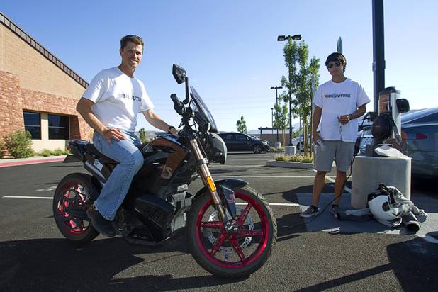 Ben Rich, left, of Montclair, New Jersey, a member of the "Ride to the Future Tour," poses on his Zero S electric motorcycle after arriving at Las Vegas Cyclery near I-215 and Town Center Drive Sunday, Aug. 4 2013. The tour of electric vehicles hopes to be certified for several Guinness World Records. The cross-country tour began July 4th in Charleston, South Carolina, and will end at Google Headquarters in Mountain View, Calif. on August 16.