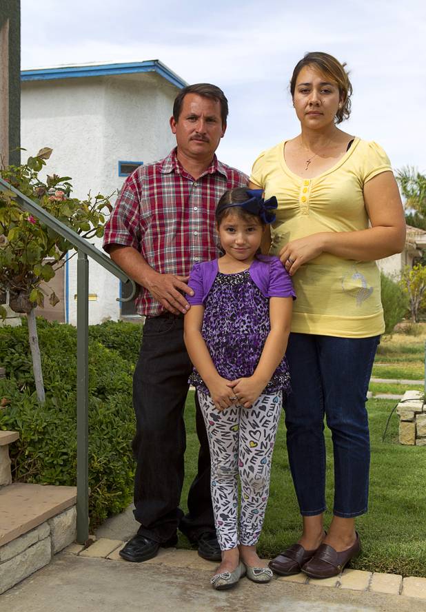 Jamileth Dominguez-Hernandez, 6, poses with her parents, Inocente Dominguez and Maria Hernandez, outside the law offices of Langford McLetchie on Monday, Aug. 5, 2013. The family is suing Metro Police for failing to properly investigate when their daughter had her foot injured in an accident in 2011.