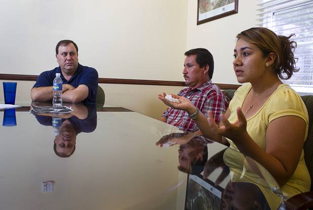 Inocente and Maria Hernandez discuss the accident that injured their daughter during an interview at the law offices of Langford McLetchie Monday, Aug. 5 2013. Attorney George Tractman listens at left. The family is suing Metro Police for failing to properly investigate when their daughter had her foot injured in an accident in 2011.