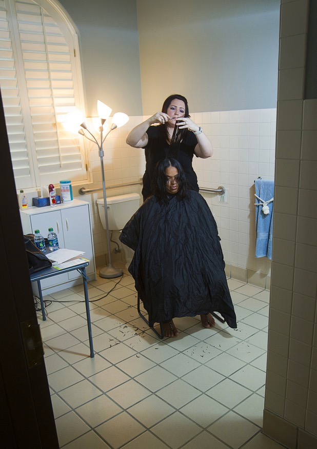 Mical Henderson cuts the hair of Sindy Alarcon at the Ronald McDonald House Monday, Aug. 5 2013. The The Ronald McDonald House provides temporary housing for families who travel to Las Vegas to receive critical medical treatment for their children.