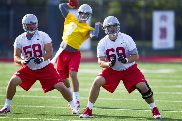 Offensive linemen Brian Roth, left, and Brett Boyko work on a drill with quarterback Nick Sherrry, center, during practice at UNLV Tuesday, Aug. 6, 2013.