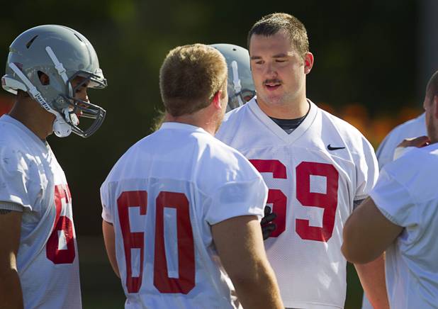 Brett Boyko (69), right, talks with teammates during practice at UNLV Tuesday, Aug. 6, 2013.