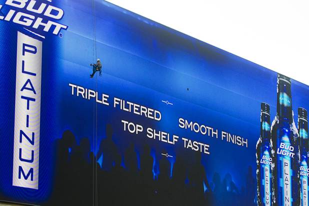 YESCO employee Paul Hemsley replaces a bad LED panel on the sign at Harmon Avenue Las Vegas Boulevard South Wednesday, Aug. 7, 2013. The sign is believed to be the worlds largest full-motion LED screen, said Jeff Young, Yesco senior vice president and chief marketing officer.