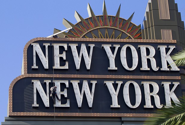 YESCO employee Dave Murray makes his way down the New York-New York marquee sign to replace a neon tube in the lettering Wednesday, Aug. 7, 2013. The lettering is about 505 feet above the ground. Mike Windham is above.