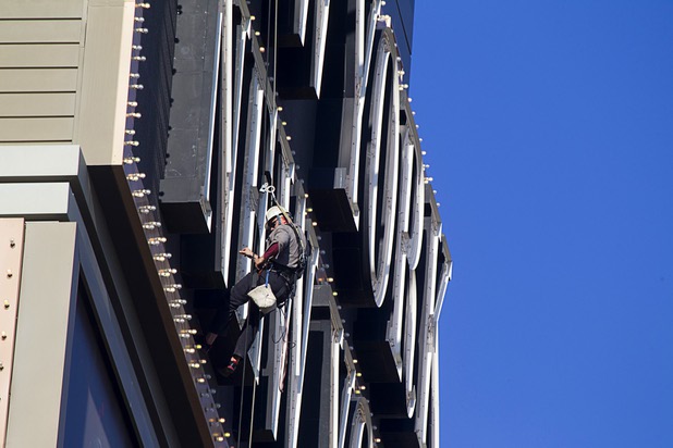 YESCO employee Dave Murray works on neon tubes on the New York New York marquee sign Wednesday, Aug. 7, 2013. The lettering is about 505 feet above the ground.