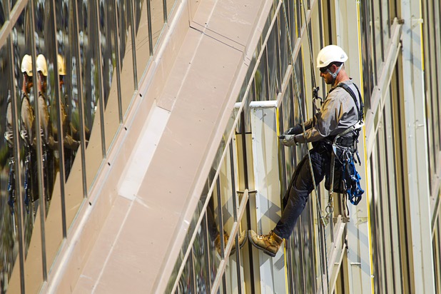 YESCO serviceman James Smith works on 9-foot neon tubes at the side of the Mandalay Bay Wednesday, Aug. 7, 2013.
