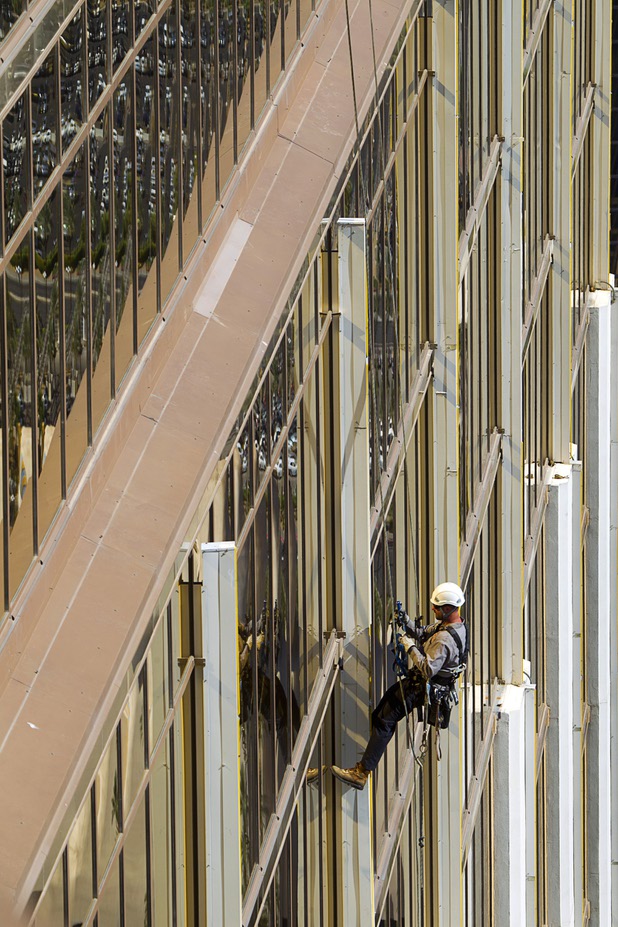 YESCO serviceman James Smith works on 9-foot neon tubes at the side of the Mandalay Bay Wednesday, Aug. 7, 2013.