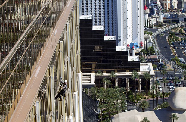 YESCO serviceman James Smith heads to the roof after working on 9-foot neon tubes at the side of the Mandalay Bay Wednesday, Aug. 7, 2013.