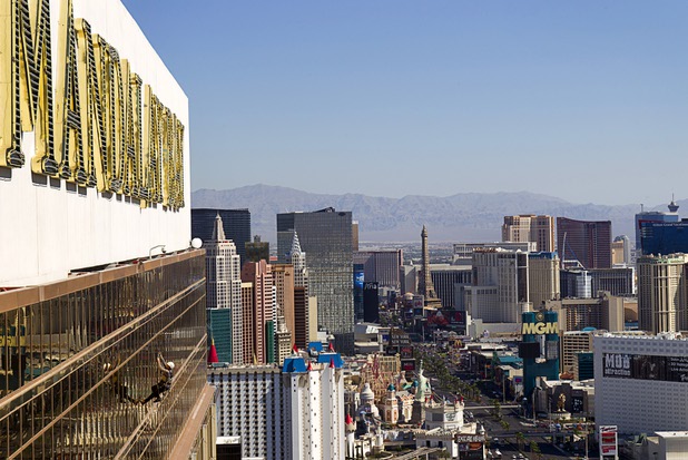 YESCO serviceman James Smith heads to the roof after working on 9-foot neon tubes at the side of the Mandalay Bay Wednesday, Aug. 7, 2013.