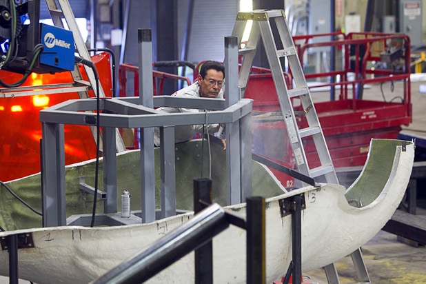 A YESCO employee puts primer on the structural support of a fiberglass flamingo sculpture at the Yesco facility in Las Vegas Wednesday, Aug. 7, 2013.