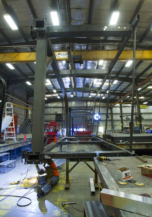 Welder Tom Scarbrough works on a support at the YESCO facility in Las Vegas Wednesday, Aug. 7, 2013. The support will hold a high definition video display system in the Energy Solutions Arena, the home of the Utah Jazz.