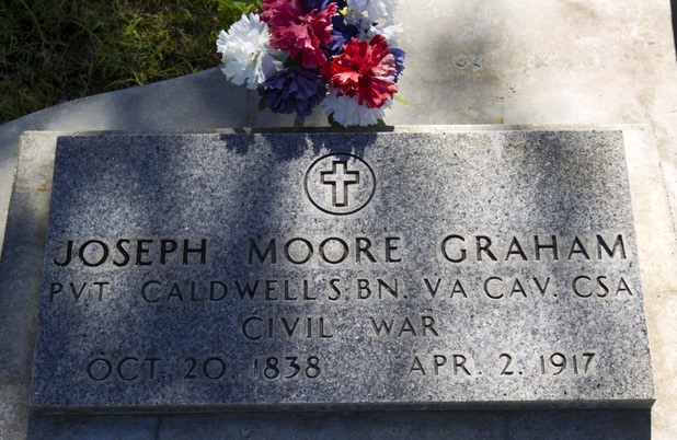 The headstone of Joseph Moore Graham is shown at Woodlawn Cemetery Thursday, Aug. 8, 2013. Graham, a Confederate soldier in the Civil War, is buried next to his friend and Union soldier William Boone Keith.