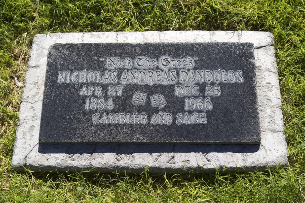 A gravestone marks the final resting place for gambler  "Nick the Greek" Dandolos at Woodlawn Cemetery Thursday, Aug. 8, 2013. Opened in 1914 on 10 acres of donated land, Woodlawn, the oldest cemetery in Las Vegas, is coming up on its 100th anniversary.