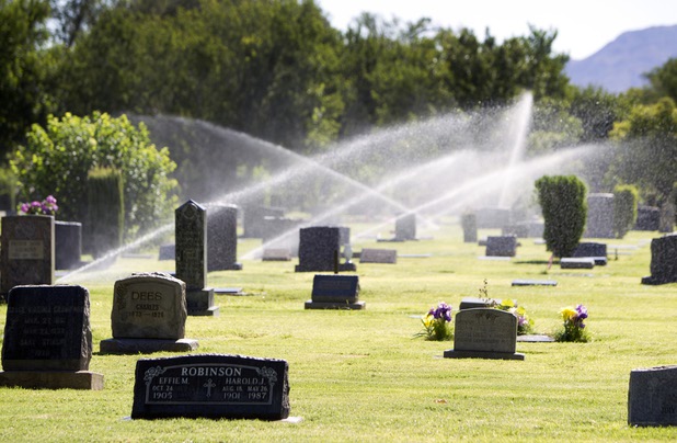 Sprinklers water the grass at Woodlawn Cemetery Thursday, Aug. 8, 2013. Opened in 1914 on 10 acres of donated land, Woodlawn, the oldest cemetery in Las Vegas, is coming up on its 100th anniversary.