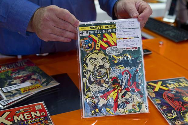 Owner Chandler Rice holds a rare X-Men comic at Supernova Comics in the Neonopolis Mall in downtown Las Vegas Thursday, Aug. 8, 2013.