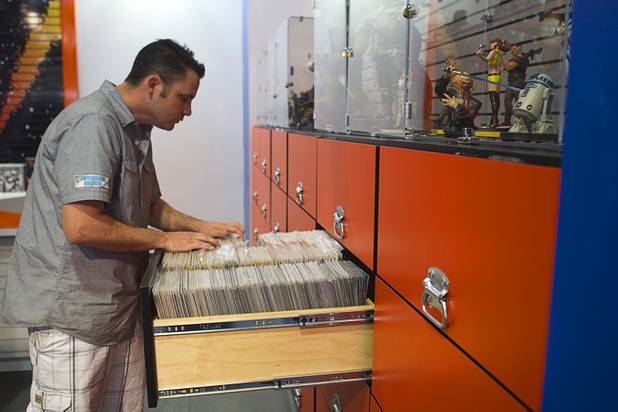 Michael Chalmers, manager of Supernova Comics, goes through a drawer of comics in the Neonopolis Mall in downtown Las Vegas Thursday, Aug. 8, 2013.