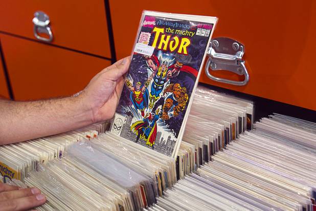 Michael Chalmers, manager of Supernova Comics, goes through a drawer of comics in the Neonopolis Mall in downtown Las Vegas Thursday, Aug. 8, 2013.