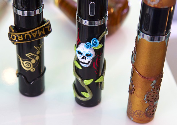 E-cigarettes, customized by local artists, are displayed at Evapor8, a hookah lounge and vapor boutique, in the Neonopolis Mall in downtown Las Vegas Thursday, Aug. 8, 2013.