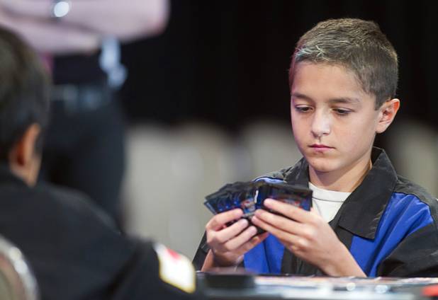 Oliver S. Tomajko of the U.S. plays against Mao Goto of Japan during the Yu-Gi-Oh! Trading Card Game world championships at Bally's Sunday, Aug. 11, 2013. Twelve players competed in the Dragon Duel for players 12-years-old and younger. Tomajko beat Goto for first prize in the division.