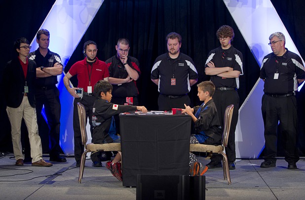 Judges and officials watch as Mao Goto, left, of Japan plays against Oliver S. Tomajko of the U.S. during the Yu-Gi-Oh! Trading Card Game world championships at Bally's Sunday, Aug. 11, 2013. Twelve players competed in the Dragon Duel for players 12-years-old and younger. Tomajko beat Goto for first prize in the division.