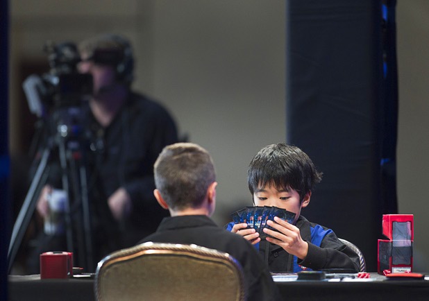 Mao Goto, right, of Japan plays against Oliver S. Tomajko of the U.S. during the Yu-Gi-Oh! Trading Card Game world championships at Bally's Sunday, Aug. 11, 2013. Twelve players competed in the Dragon Duel for players 12-years-old and younger. Tomajko beat Goto for first prize in the division.