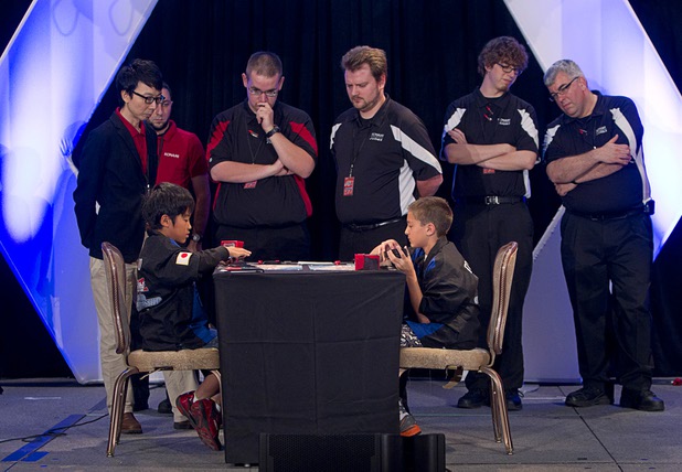 Judges and officials watch as Mao Goto, left, of Japan plays against Oliver S. Tomajko of the U.S. during the Yu-Gi-Oh! Trading Card Game world championships at Bally's Sunday, Aug. 11, 2013. Twelve players competed in the Dragon Duel for players 12-years-old and younger. Tomajko beat Goto for first prize in the division.