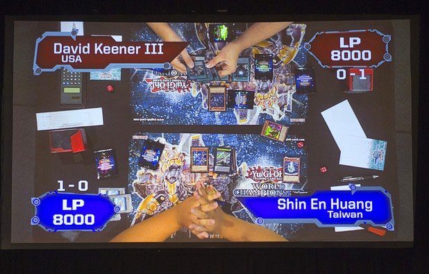 Shin En Huang, left, of Taiwan competes against David Keener II of the U.S. during the Yu-Gi-Oh! Trading Card Game world championships at Bally's Sunday, Aug. 11, 2013. Twenty-six players of the best players from around the world competed in the tournament. Huang defeated Keener to take the wold championship title.