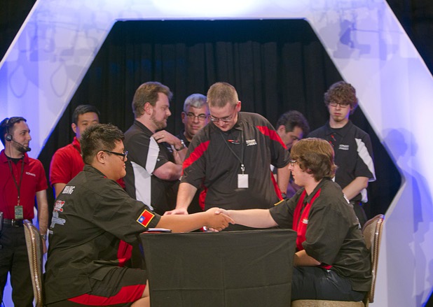 Shin En Huang, left, of Taiwan shakes hands with David Keener II of the U.S. after beating Keener in the final match of the Yu-Gi-Oh! Trading Card Game world championships at Bally's Sunday, Aug. 11, 2013. Twenty-six players of the best players from around the world competed in the tournament.