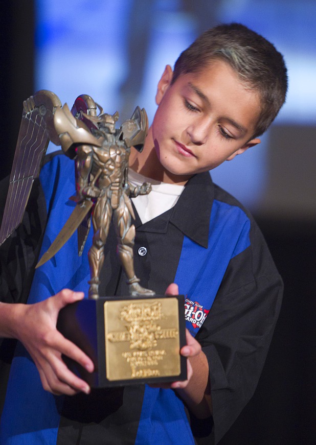 Oliver S. Tomajko of the U.S. looks over his first place trophy during the Yu-Gi-Oh! Trading Card Game world championships at Bally's Sunday, Aug. 11, 2013. Twelve players competed in the Dragon Duel for players 12-years-old and younger. The battle-based card game by Konami was named the top selling trading card game in the world by Guinness World Records in 2009.