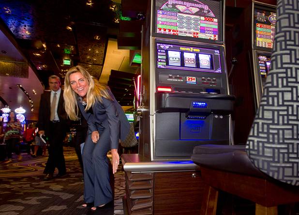 Phyllis Cuttino, director of Pews Clean Energy Program, puts her hand by an air condition vent under a slot machine on Aria's casino floor during a tour of CityCenters sustainable features and cogeneration plant Monday, Aug. 12, 2013. One of the advantages of lower vents is that the air doesn't need to be as cold compared to air that comes from overhead vents. Cuttino is town to attend the National Clean Energy Summit 6.0 which begins Tuesday, Aug. 13 at Mandalay Bay.