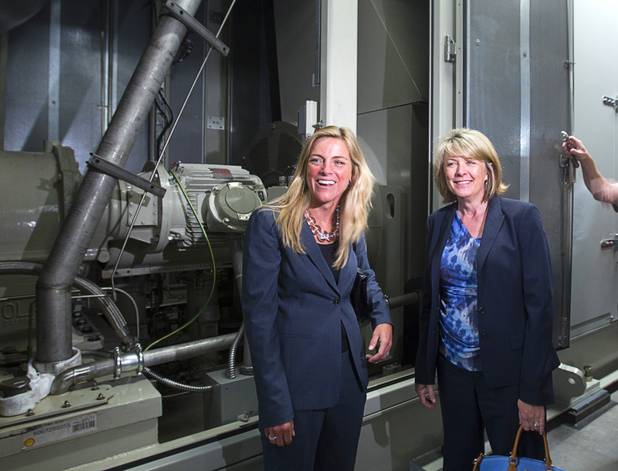 Phyllis Cuttino, left, director of Pews Clean Energy Program, and Cindy Ortega, senior vice president and chief sustainability officer of MGM Resorts, pose by a natural gas turbine for generating electricity during a tour of CityCenters sustainable features and cogeneration plant Monday, Aug. 12, 2013. Waste heat from the process is re-used to heat water for the property.