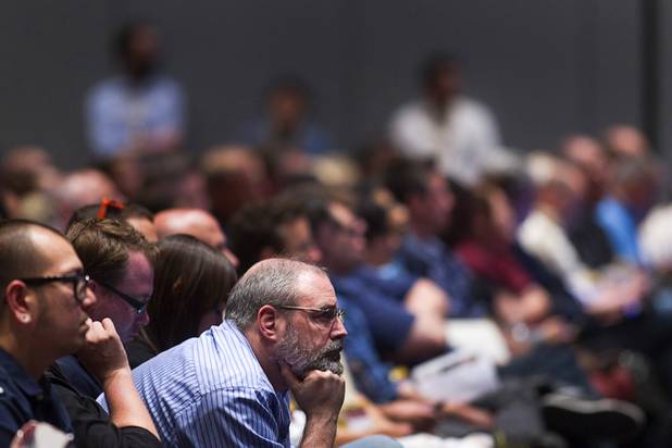 A ballroom full of people listen to Tony Hsieh, CEO of Zappos, as he gives a keynote address at the South By Southwest V2V tech conference for entrepreneurs at the Cosmopolitan Monday, Aug. 12, 2013.