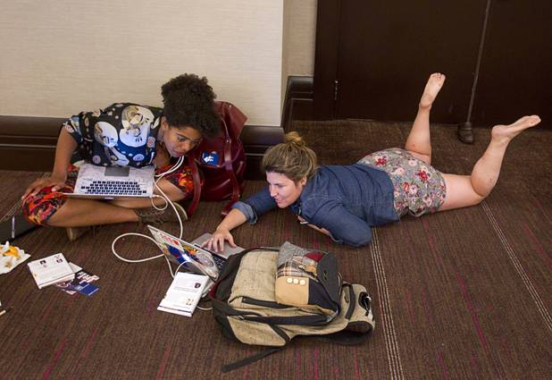 Madison Maxey, left, and Ashley Jennings work on the floor of a hallway during the South By Southwest V2V tech conference for entrepreneurs at the Cosmopolitan Monday, Aug. 12, 2013. Maxey, co-founder of Crated, was a speaker at the event.