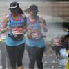 Runners cool down running through water sprays on the route during the London Marathon, London, Sunday, April 21, 2013. 
