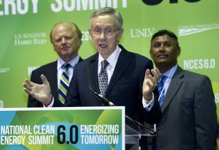 Senate Majority Leader Harry Reid, center, (D-NV) speaks during a news conference at the National Clean Energy Summit 6.0 at the Mandalay Bay Tuesday, Aug. 13, 2013. The Moapa Band of Paiutes announced they will begin construction on a large-scale photovoltaic facility on Moapa River Indian Reservation land northeast of Las Vegas. Behind Reid are Gerrit Nicholas, managing partner of K Road Power, and Eric Lee, acting chairman from the Moapa Band of Paiute Indians.