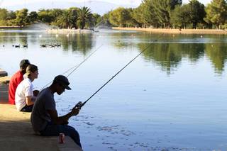 Teenagers fish at Sunset Park in Las Vegas on Tuesday, August 13, 2013.