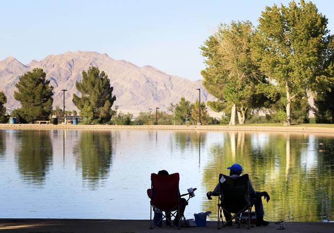 People enjoy the lake view while fishing at Sunset Park in Las Vegas on Tuesday, August 13, 2013.