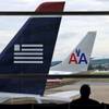 An American Airlines plane and a US Airways plane are parked at Washington's Ronald Reagan National Airport in Washington, Aug. 13, 2013.