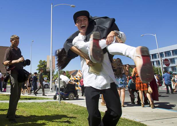 Edgar Villalobos, 19, celebrates with his girlfriend Vanessa Garcia, 18, following the Clark County School District's second annual summer high school graduation ceremony for summer school graduates and at-risk students at the Las Vegas Academy in downtown Las Vegas Wednesday, Aug. 14, 2013. Garcia, who gave birth to their daughter two months ago, graduated from CCSD's Academy of Individual Studies.