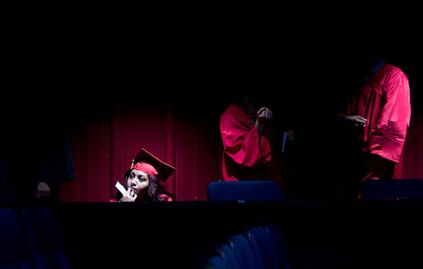 Katherine Hernandez of the Southwest Career and Technical Academy, waits in a theater before the start of the Clark County School District's second annual summer high school graduation ceremony for summer school graduates and at-risk students at the Las Vegas Academy in downtown Las Vegas Wednesday, Aug. 14, 2013.