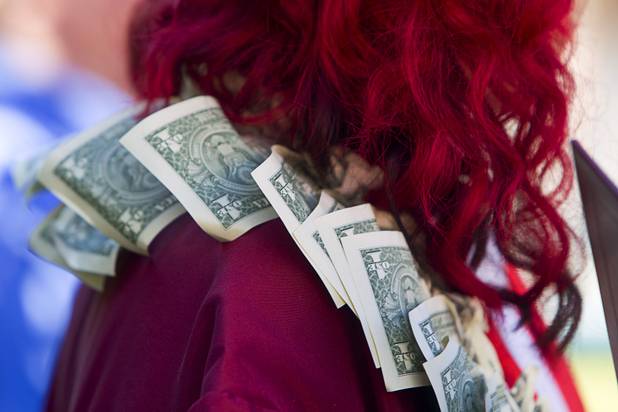 Cimarron-Memorial High School graduate Jade Hase wears a lei made of dollar bills after the Clark County School District's second annual summer high school graduation ceremony for summer school graduates and at-risk students at the Las Vegas Academy in downtown Las Vegas Wednesday, Aug. 14, 2013.