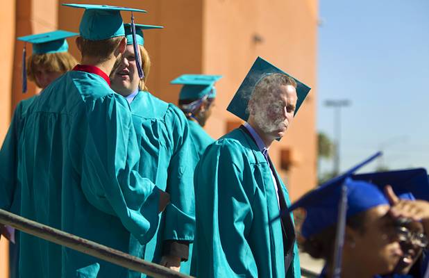 Victor Coleman of Silverado High School grabs a quick smoke before the Clark County School District's second annual summer high school graduation ceremony for summer school graduates and at-risk students at the Las Vegas Academy in downtown Las Vegas Wednesday, Aug. 14, 2013.