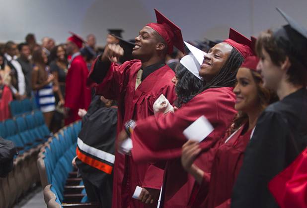 Graduates turn and thank family members during the Clark County School District's second annual summer high school graduation ceremony for summer school graduates and at-risk students at the Las Vegas Academy in downtown Las Vegas Wednesday, Aug. 14, 2013.