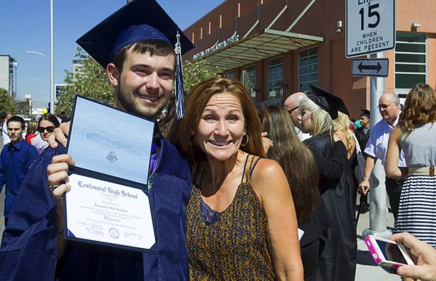 Alex Godwin of Centennial High School poses with Donna Mack, his first grade teacher, following the Clark County School District's second annual summer high school graduation ceremony for summer school graduates and at-risk students at the Las Vegas Academy in downtown Las Vegas Wednesday, Aug. 14, 2013.