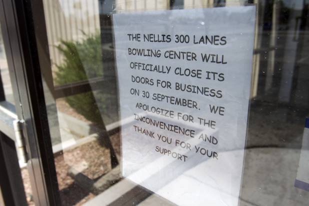 A sign is posted on the door of the closed bowling alley on Nellis Air Force Base Thursday, Aug. 15, 2013.